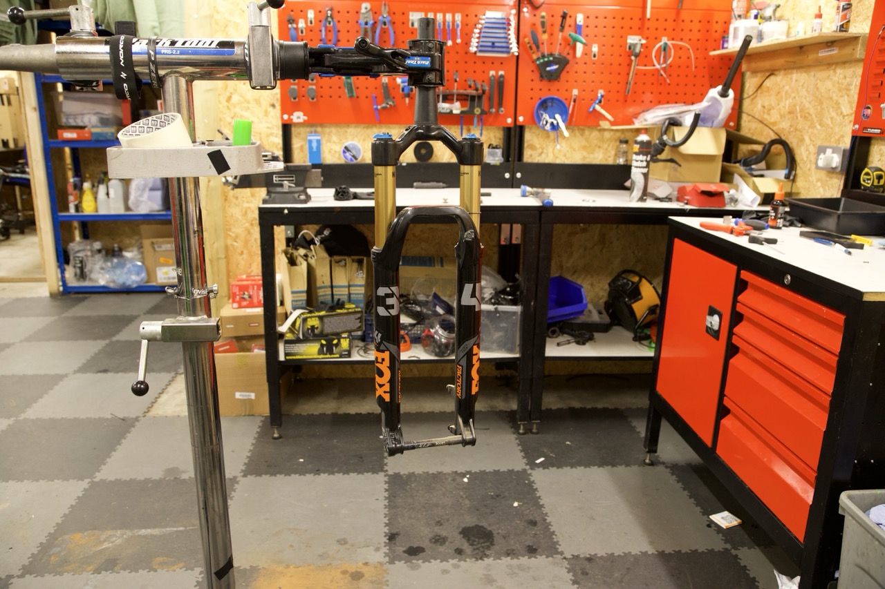 Fox fork lowers mounted in the workshop stand during service