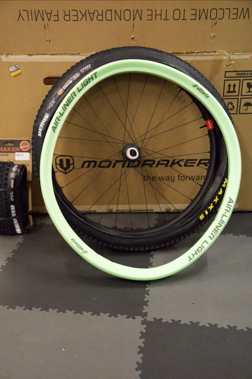 The new Maxxis Forekaster and Rekon tyres beside their packaging